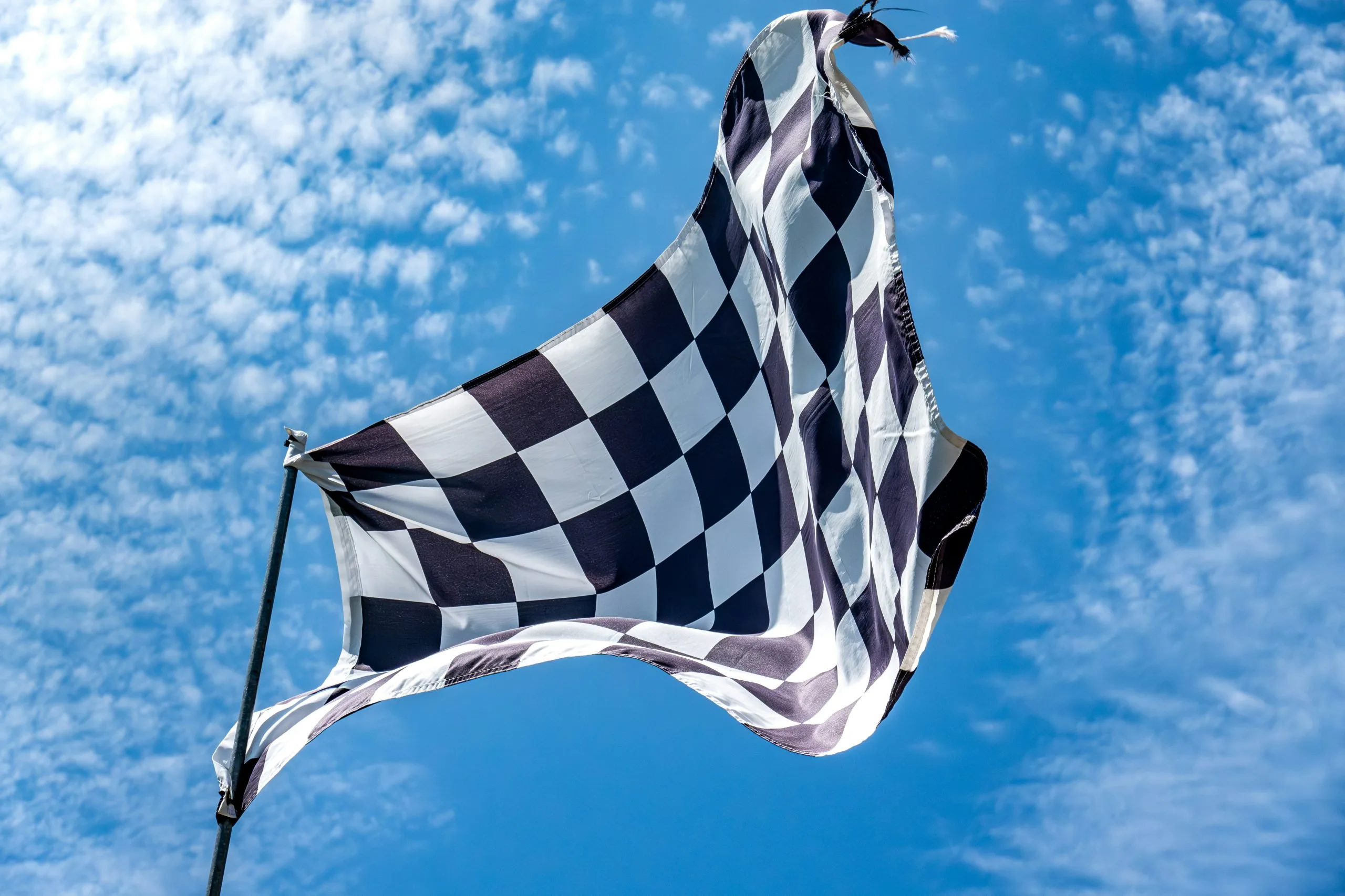 Photo by <a href="https://unsplash.com/@chris_robert?utm_source=unsplash&utm_medium=referral&utm_content=creditCopyText">chris robert</a> on <a href="https://unsplash.com/photos/a-black-and-white-checkered-flag-flying-in-the-sky-65oNjZMX5NY?utm_source=unsplash&utm_medium=referral&utm_content=creditCopyText">Unsplash</a>